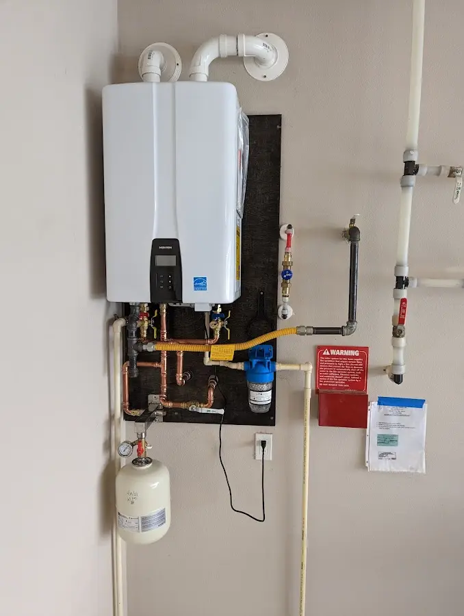 Professional plumber installing copper piping in a Susanville home